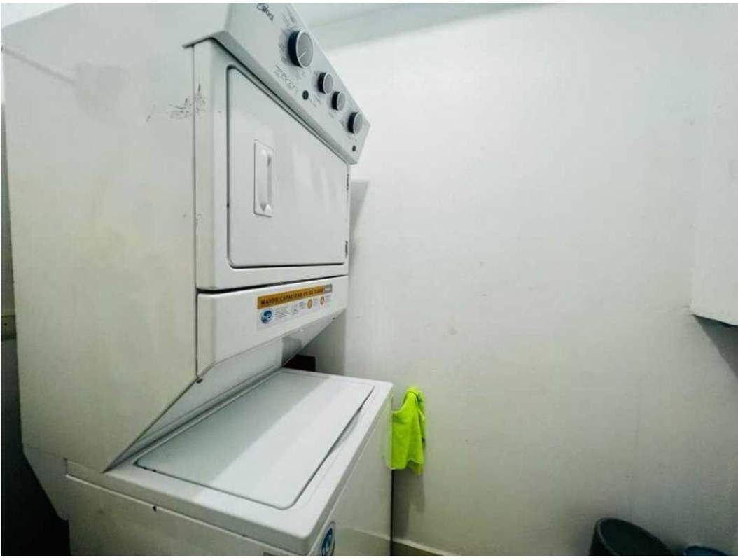 Modern laundry area with washer and dryer in PH Rivage Tower luxury apartment Panama