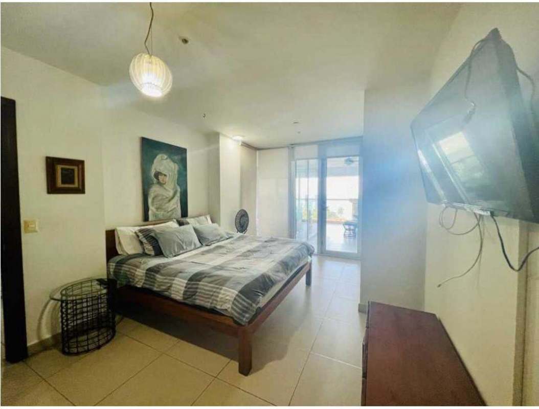 Minimalist modern living room with terrace access facing ocean at PH Rivage Tower Panama