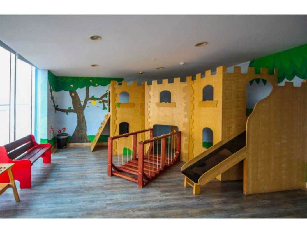 Indoor themed children's playroom with castle structure and murals at PH Rivage Tower