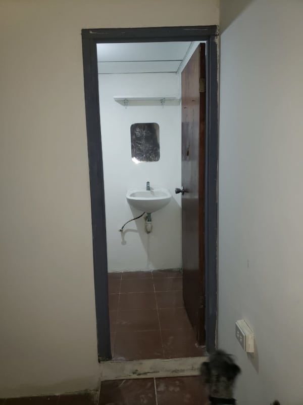 Minimalist bathroom with wall sink, small mirror and tiled floors rental house Hato Pintado Panama City