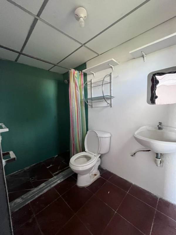 Small bathroom with toilet shower sink in budget rental Panama City