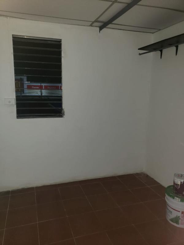 Simple indoor passageway with tiles, white walls and doorway in affordable Panama rental Hato Pintado