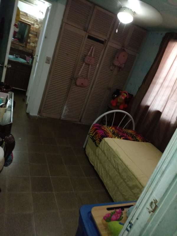Bedroom with built-in closet, tile floor, decor details in Santa Clara Panama home for sale