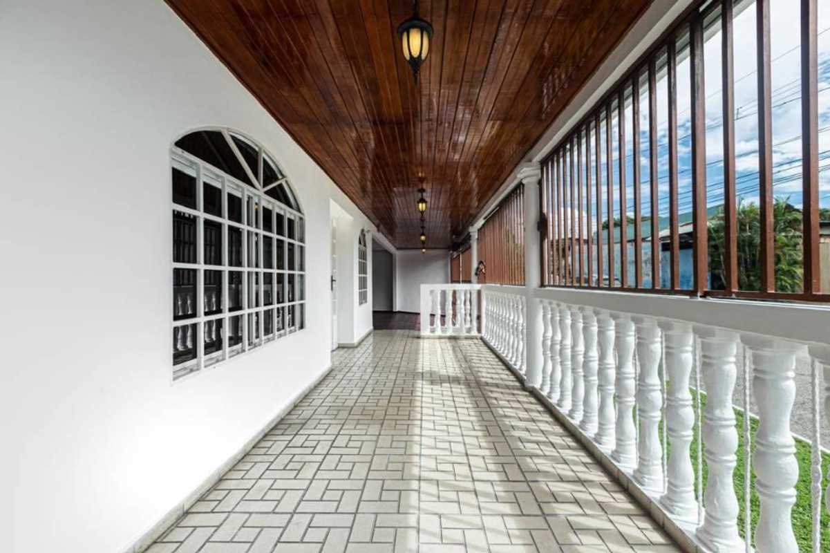 Colonial style covered veranda with arches and decorative railings in Panama City