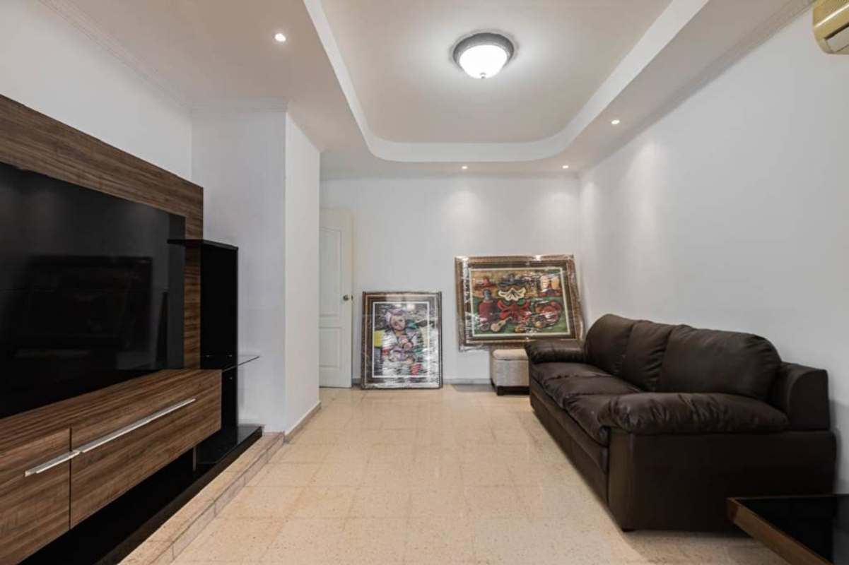 Mediterranean style single story house with terracotta roof, gated driveway, decorative columns in Panama City