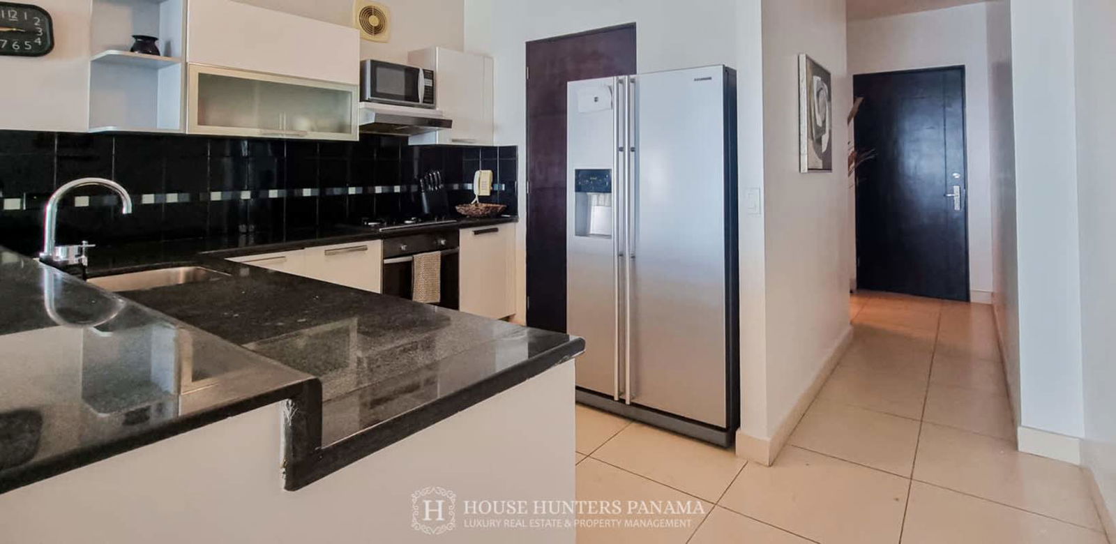 Modern bedroom with panoramic window city and ocean view double bed and wardrobe Destiny Tower Panama City