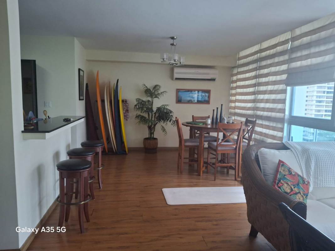 Dining area with surf decor, large windows, modern furniture inside PH Bayfront Tower Avenida Balboa Panama