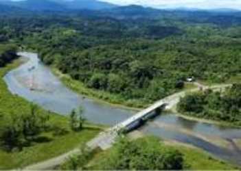 River winding through lush forest emptying near Cuango Caribbean coastline in Panama