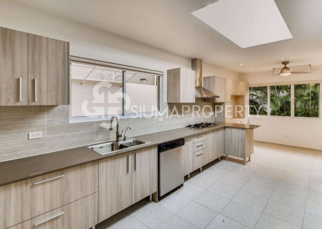 Large private pool with covered patio and landscaped garden at luxury house in Costa del Este Panama