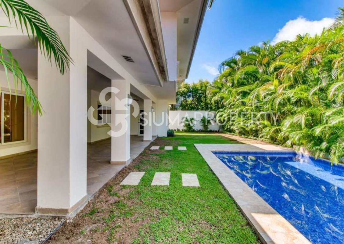 Covered marble terrace with ceiling fans overlooking private pool Costa del Este house Panama