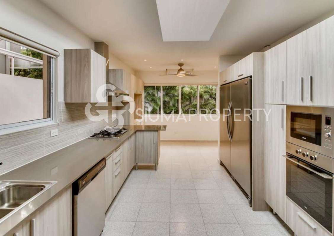 Bright spacious double height living room with marble floors and balcony in Costa del Este Panama house