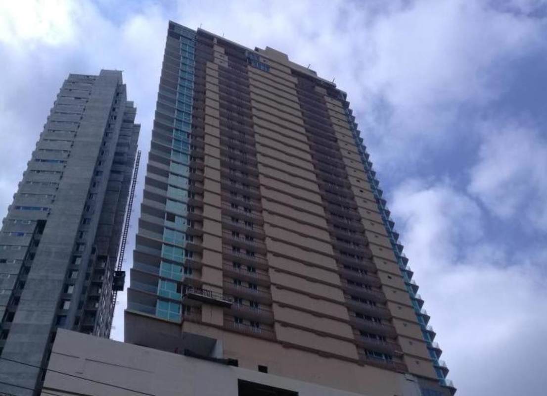 Modern high-rise residential tower with balconies PH Coco Place Coco del Mar