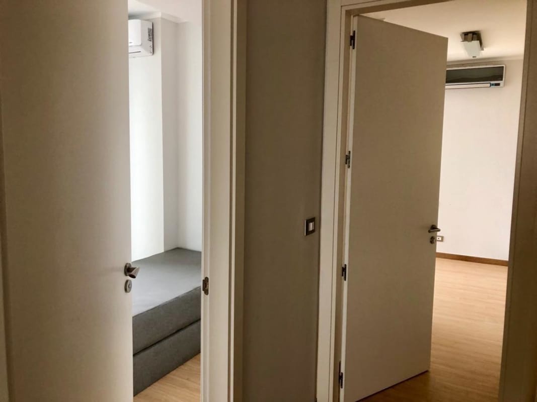 Bedroom with glass windows and ocean view in PH Coco Place Panama City