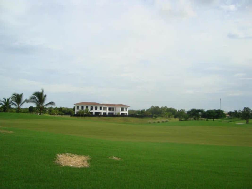 Open green field overlooking Nicklaus Design golf course in Santa Maria Country Club Panama