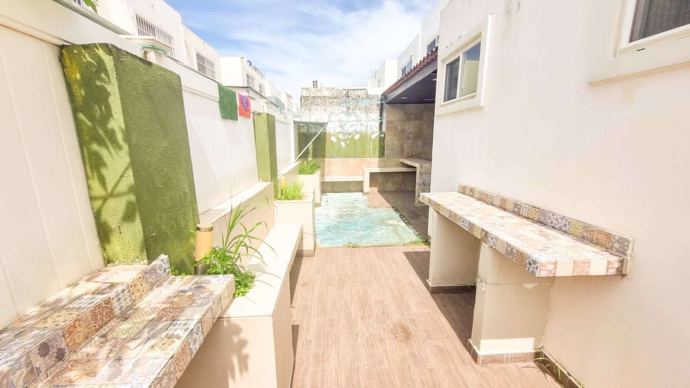 Outdoor patio area with small pool and decorative wall in PH Alpes Panama