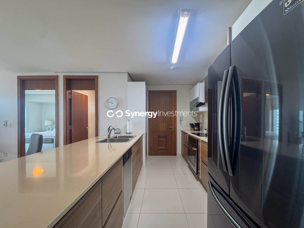 Living room with ocean view, marble floors and furnished balcony at PH Parkside Costa del Este Panama