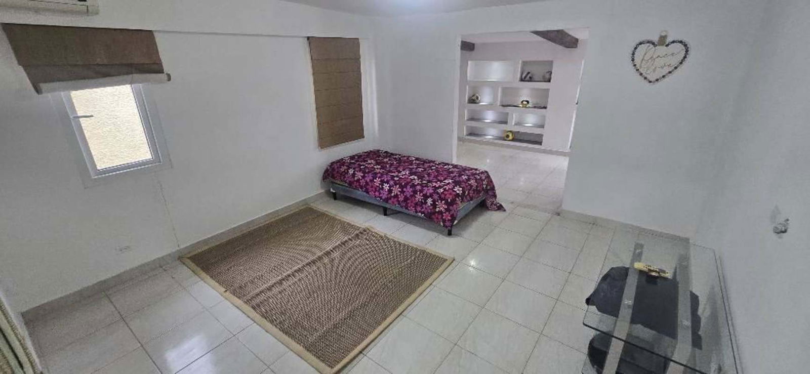 Large dining area with white table and recessed lighting in home Costa del Este
