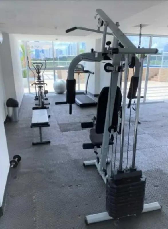 Modern gym with equipment and city views at PH Arenas Park Parque Lefevre Panama
