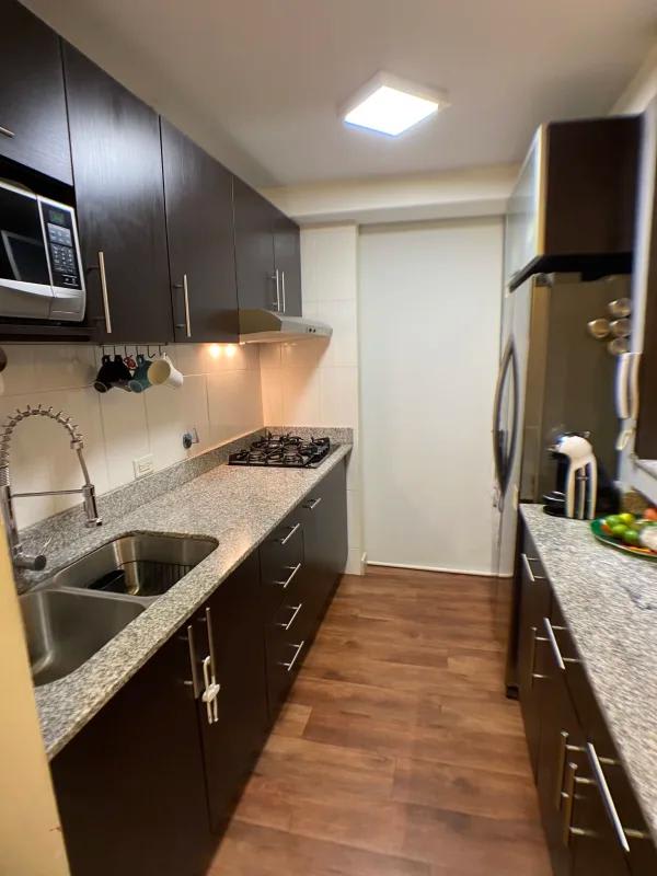 Granite countertop kitchen equipped with modern appliances in PH Arenas Park Panama
