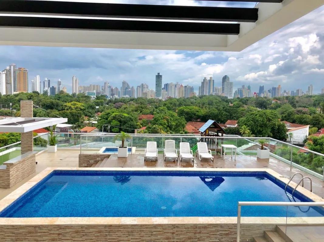 Swimming pool area with pergola and city skyline at PH Arenas Park Parque Lefevre Panama