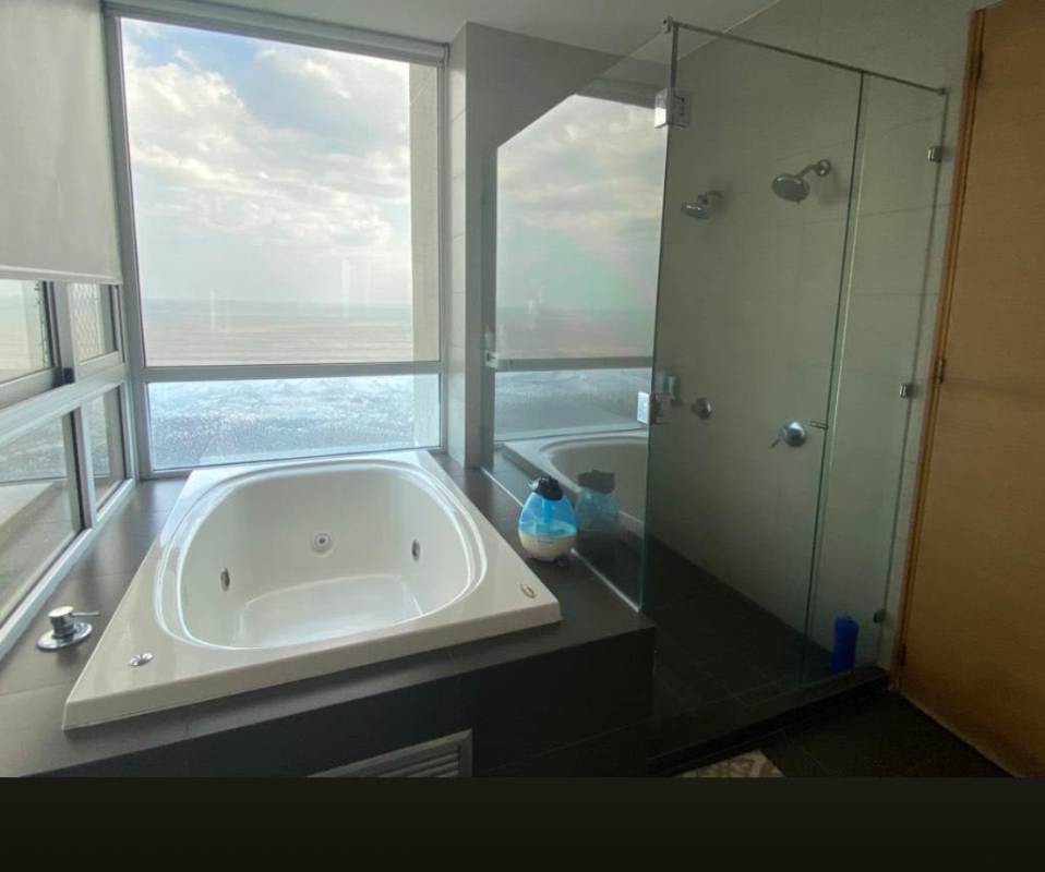 Modern bathroom with soaking tub and glass shower, floor-to-ceiling ocean views PH Altamar Costa del Este Panama