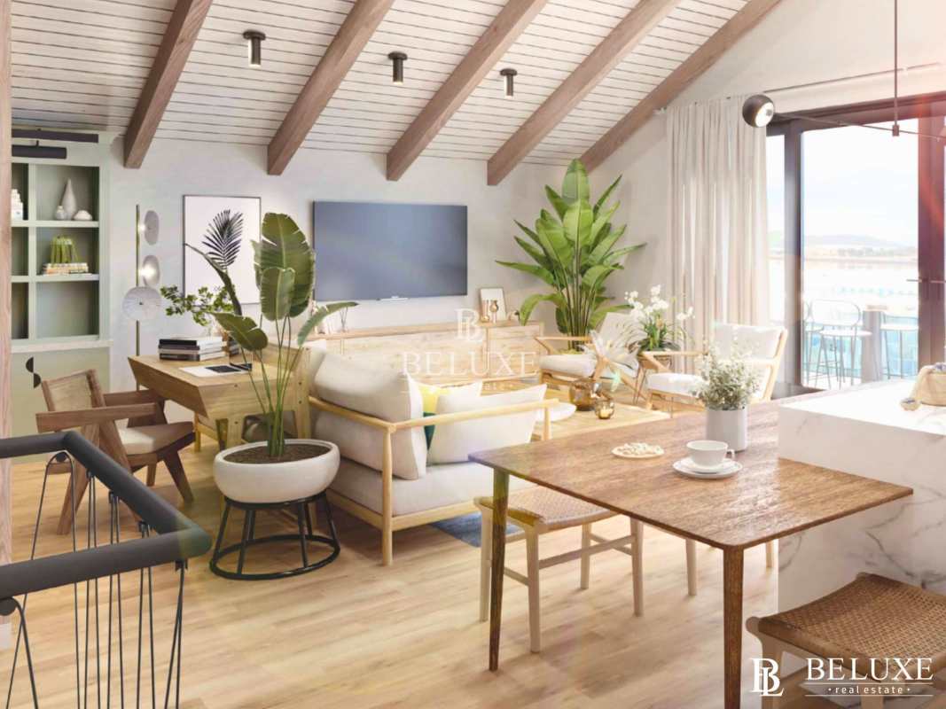 Living and dining area with vaulted ceiling beams, large windows, wooden floors at PH Plaza Novena Casco Viejo