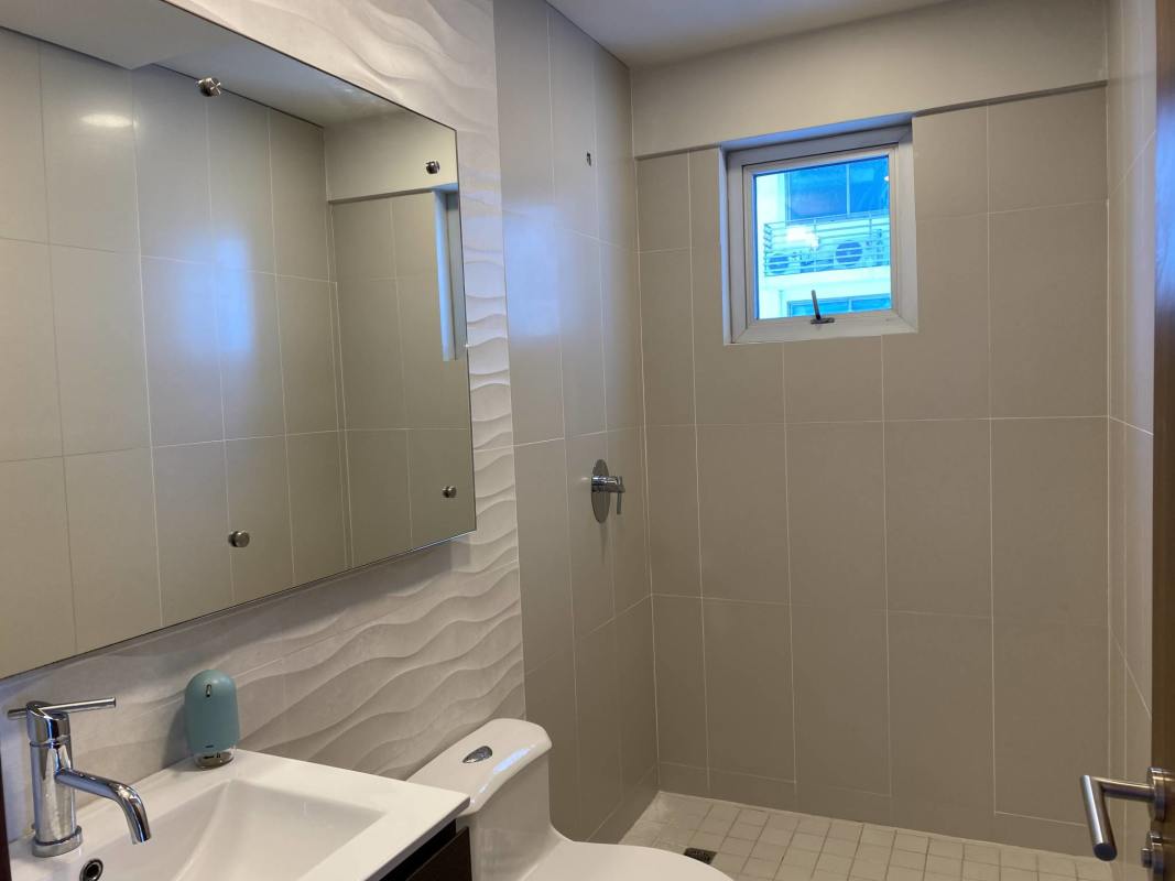 Modern bathroom with double vanity sinks glass shower in PH Parkside Costa del Este Panama