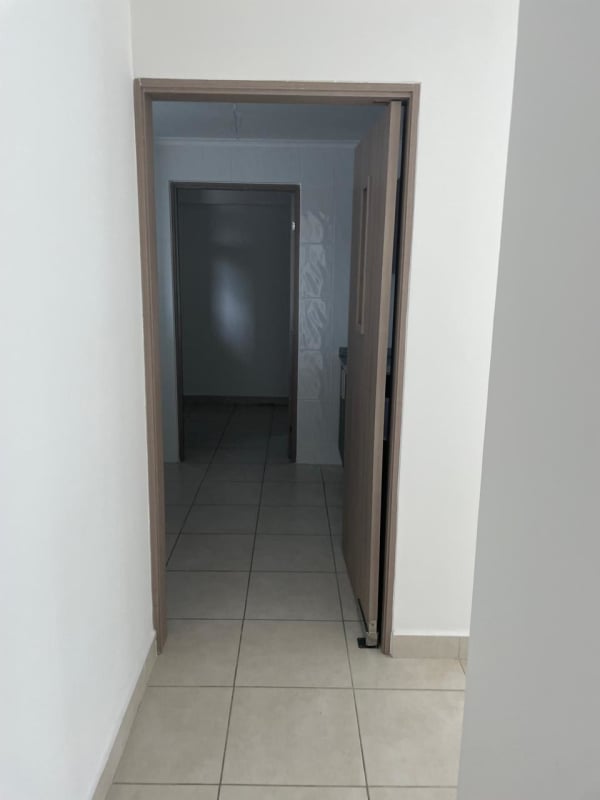 Hallway with ceramic tile floors and wooden door trims inside PH Mare 700 Edison Park Panama