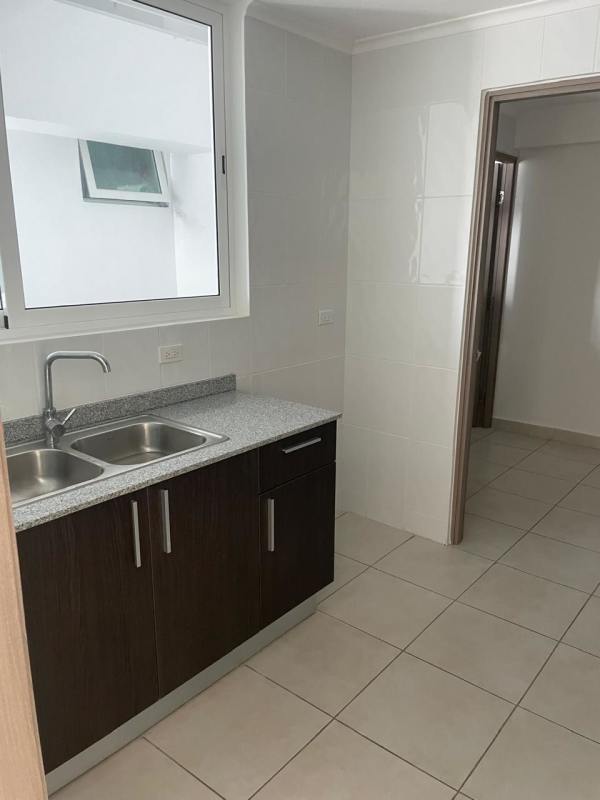 Modern kitchen with granite countertops, dark cabinets, large window PH Mare 700 Edison Park Panama