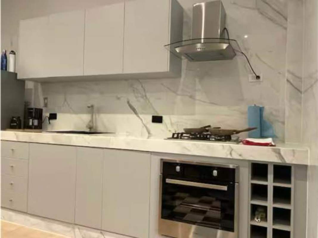 Stylish kitchen marble counters, built-in oven, minimalist cabinetry in PH Las Monjas Panama