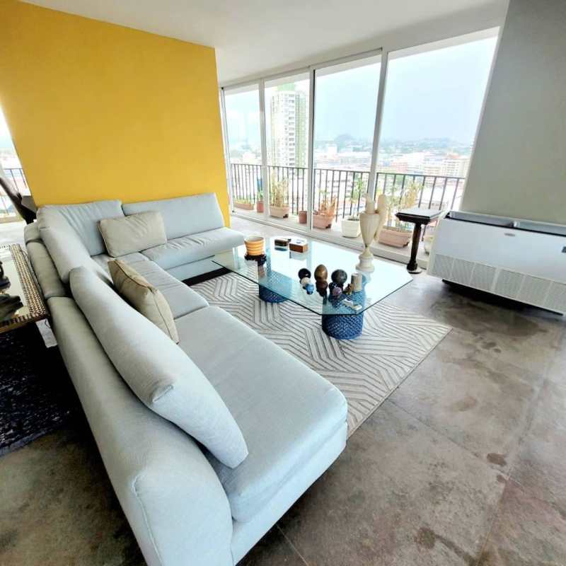 Traditional dining area with large table, wooden cabinet, and bright windows in PH Edificio Ailin Panama City