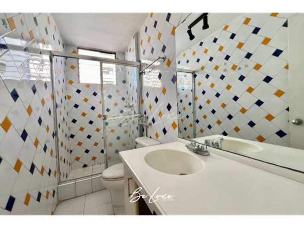 Luxurious bathroom with marble finishes, glass enclosure, double sink vanity in penthouse Panama