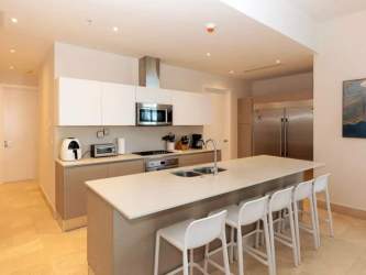 Modern kitchen with island, stainless appliances at Marina Village Buenaventura Panama