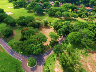 Aerial lot image bordered by lush greenery, mature trees, and lagoon inside Buenaventura, Río Hato Panama