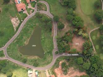 Top-down view of residential plots, water features, and landscaped community in Buenaventura Panama
