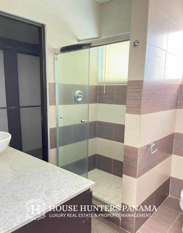 Modern bathroom with vessel sink, striped tiles, glass shower in The View Tower Panama City