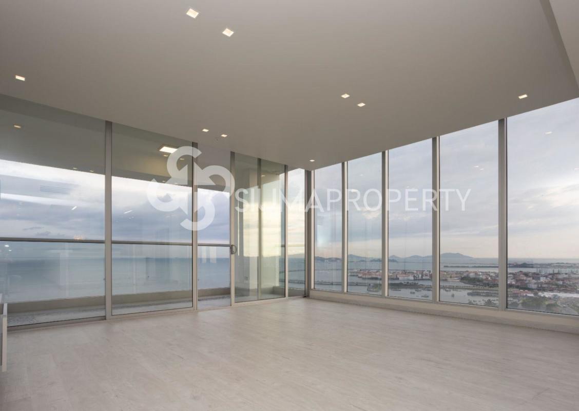 Bright living room featuring expansive oceanfront windows at PH Rivage Tower Panama City