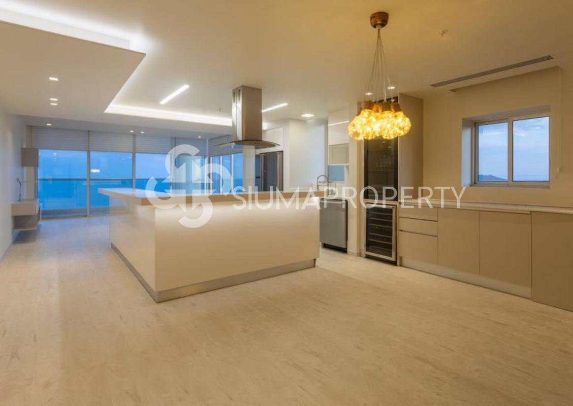 Modern kitchen with minimalist design and island facing ocean views in PH Rivage Panama City