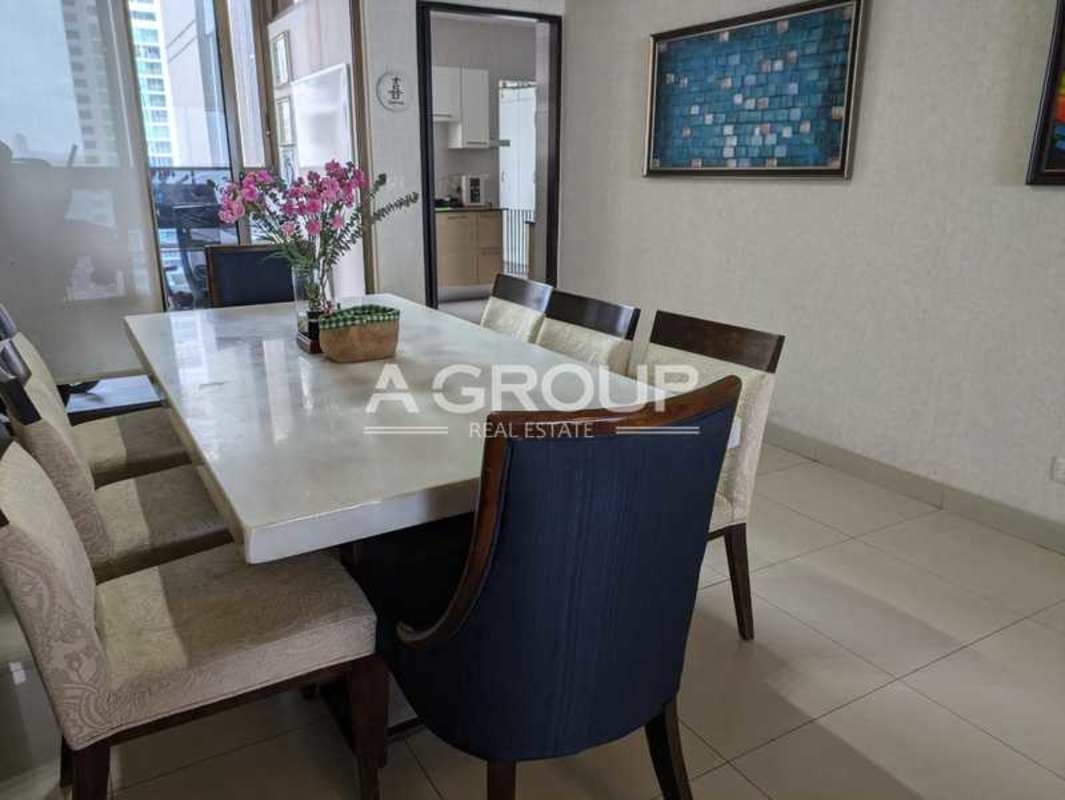 Spacious open hall with lounge area, piano, stone accent wall, entertainment center in Panama apartment
