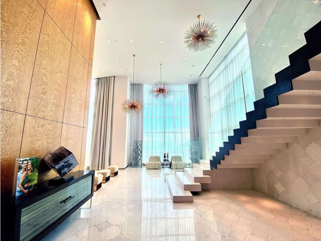 Luxury kitchen with marble island, stainless appliances, and panoramic city views at Pacific Point Tower 200 Panama