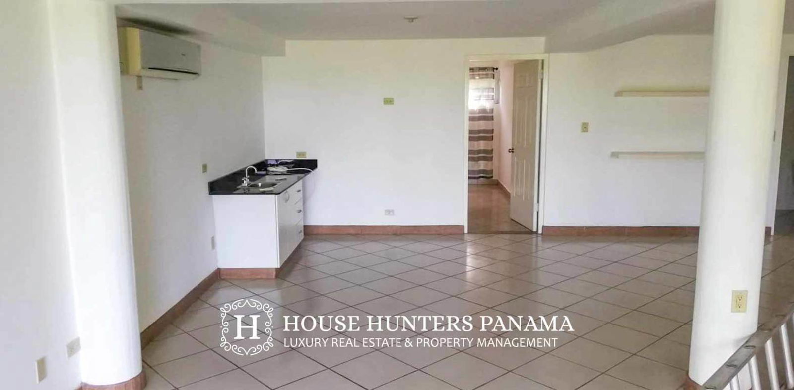 Dining space with large windows and garden views in Cerro Ancón home Panama