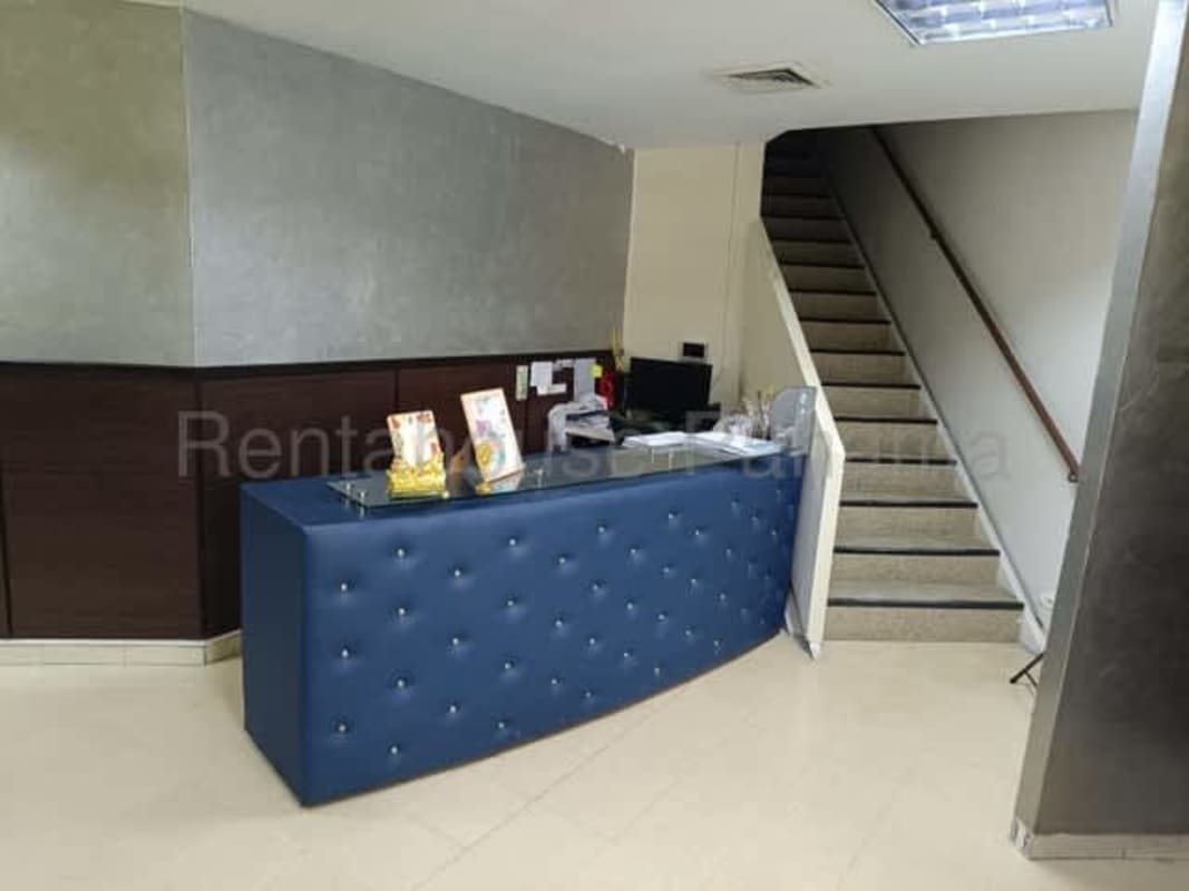 Reception area with curved desk, stairway to offices, in commercial space Rio Abajo plaza