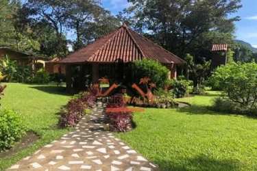 Outdoor pavilion with hammocks tiled roof lush garden in El Valle de Anton Panama estate