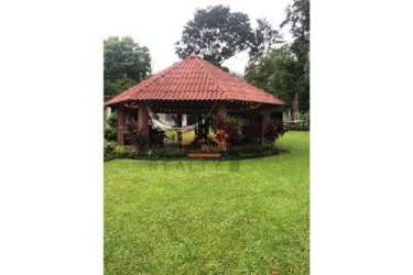 Gazebo with terracotta roof lush gardens lawn and mountain views on El Valle de Anton estate Panama