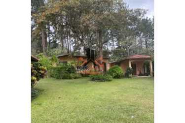 Rustic country house surrounded by green lawn tropical plants and mountain views in El Valle Panama