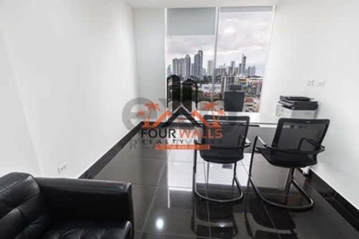 Glass-walled conference room with TV, seating and city panorama PH Office One Obarrio