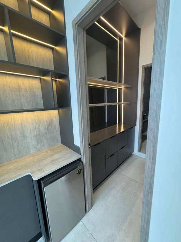 Executive office with ocean and skyline views, built-in shelving and TV at PH BICSA Panama