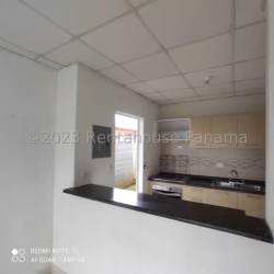 Open kitchen with granite countertop and pass-through window Costa Verde Montelimar Panama