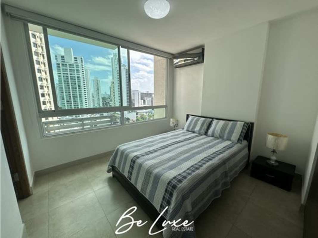 Spacious living area with large sliding glass doors to balcony and bay views in PH Terrasol Panama City