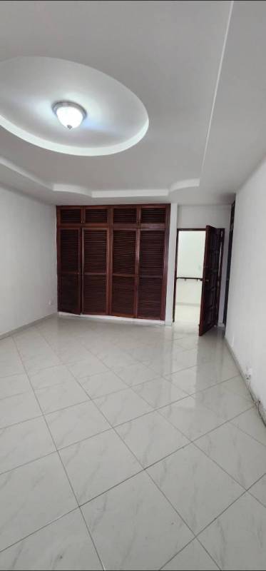 Empty living room with ceramic floor, recessed lighting, arched windows, AC in rental house Altos del Chase Panama